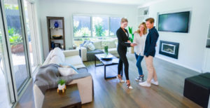 Three persons are talking in the living room